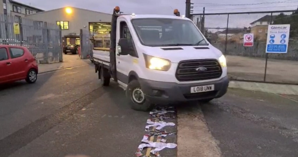 a van driving over the paper dolls