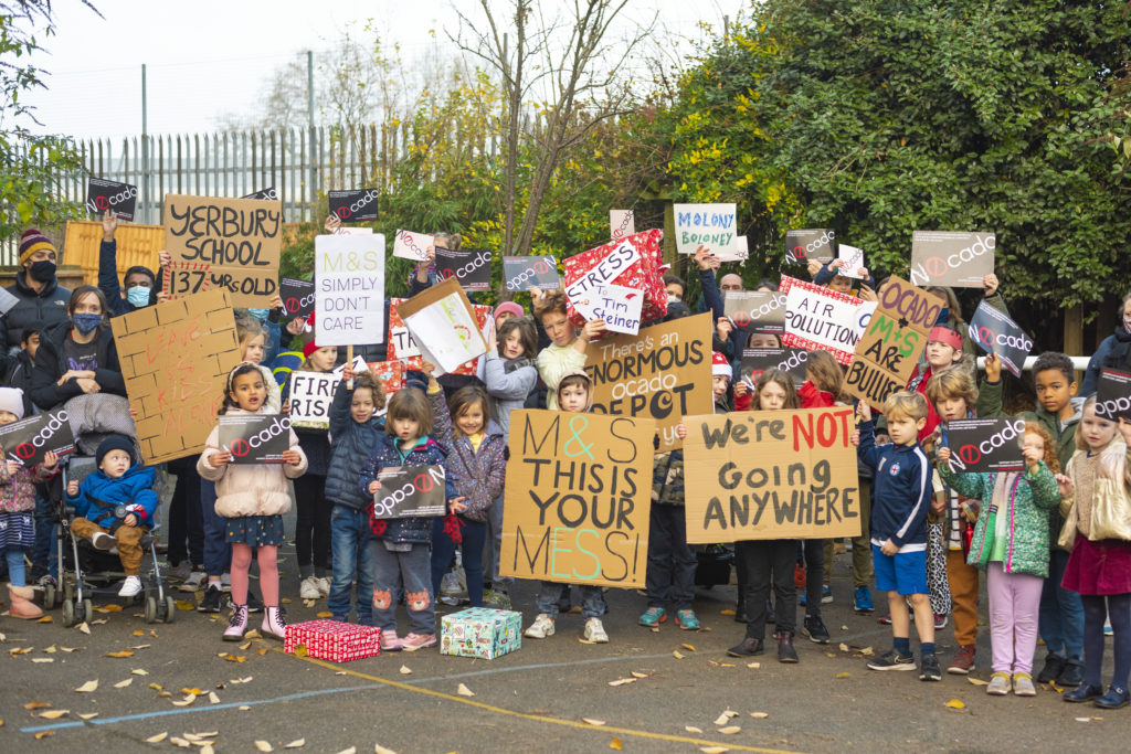 Kids and parents demonstrating in front of the boundary with the proposed depot site